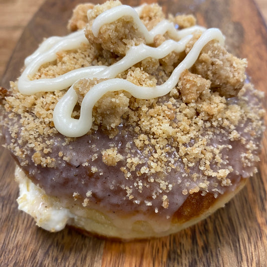 Brioche doughnut filled with fresh peach cheesecake filling topped with streusel crumb and cream, peaches and cream cheesecake doughnut Niagara foodies, St. Catharines