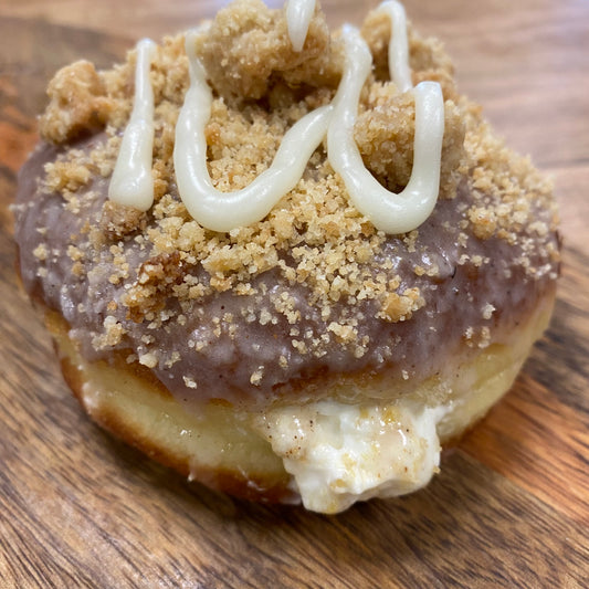 Brioche doughnut filled with fresh peach cheesecake filling topped with Stuart crumb and cream, peaches and cream cheesecake doughnut Niagara foodies, St. Catharines 